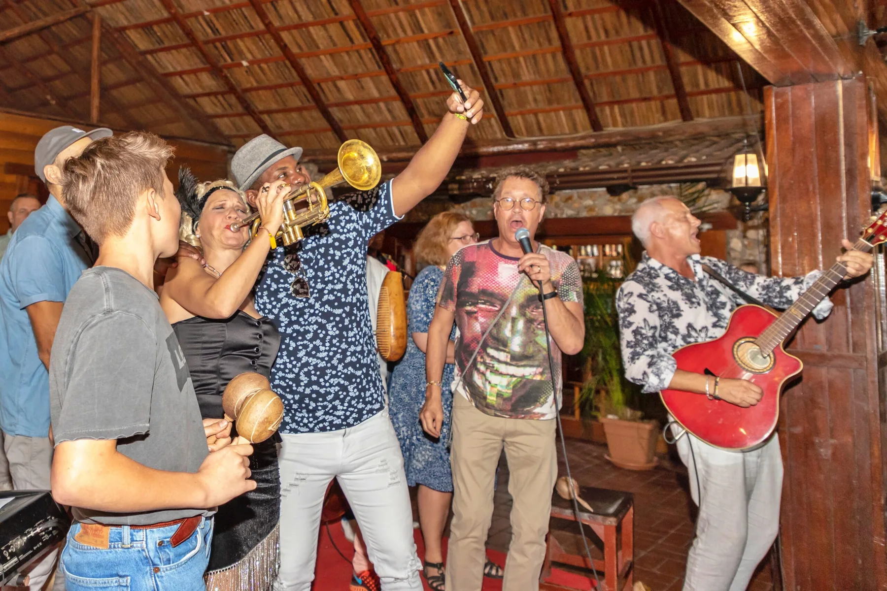 A team celebrating together with live music during a corporate retreat evening