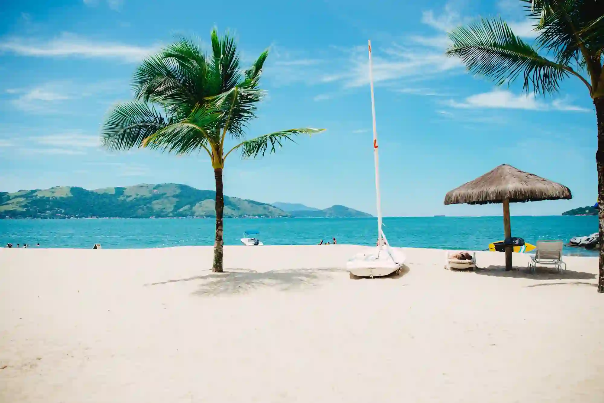 Palm-shaded beach with a palapa at a Riviera Maya hotel