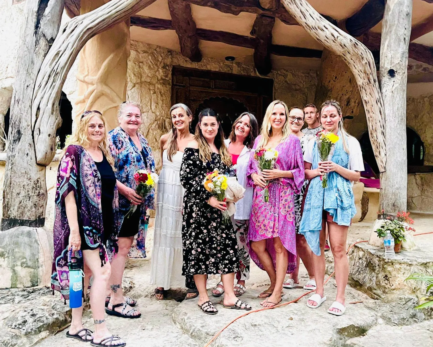 A Jungle Reboot group holding flowers in the jungle lodge