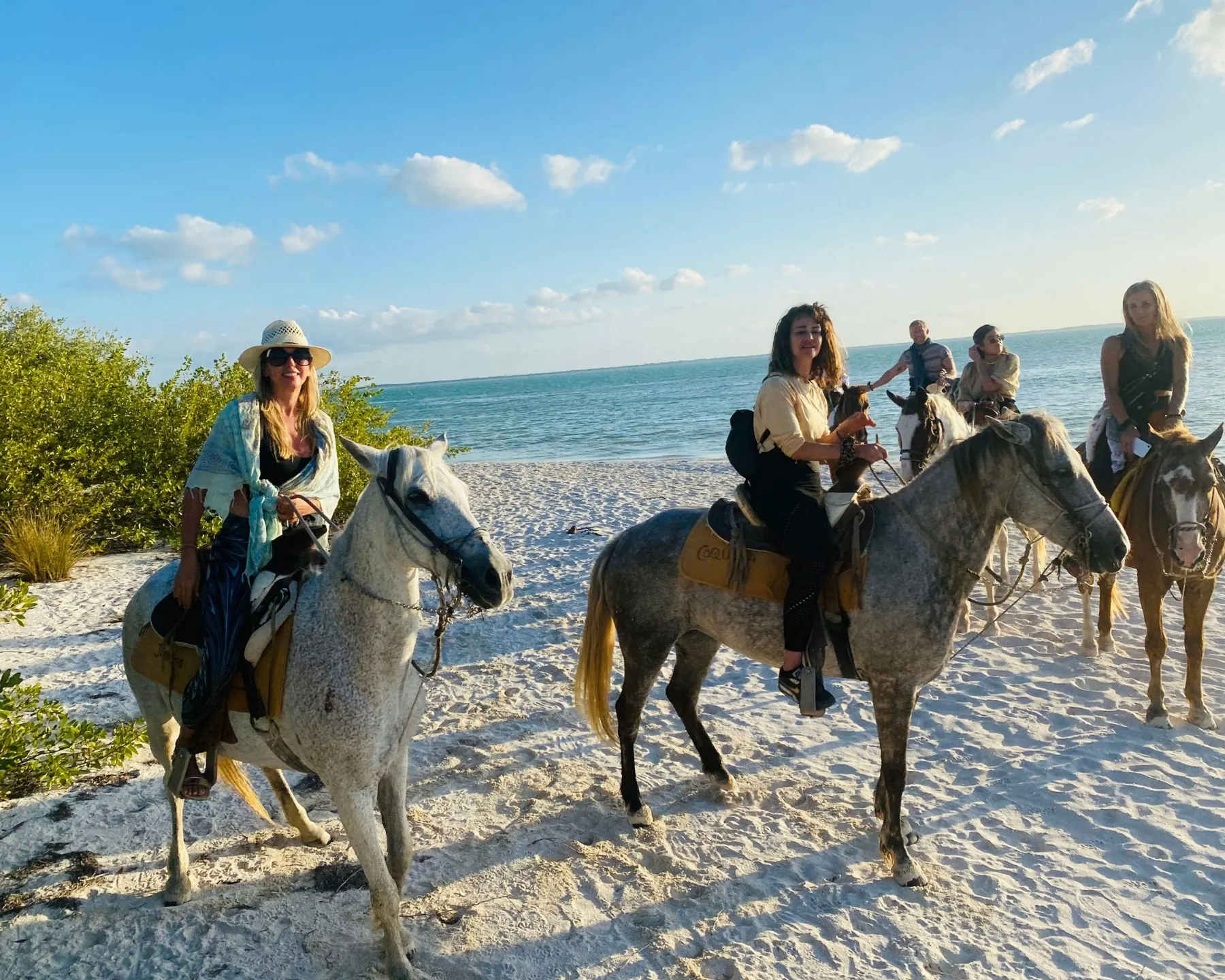 Reset & Recharge guests horse riding on the beach