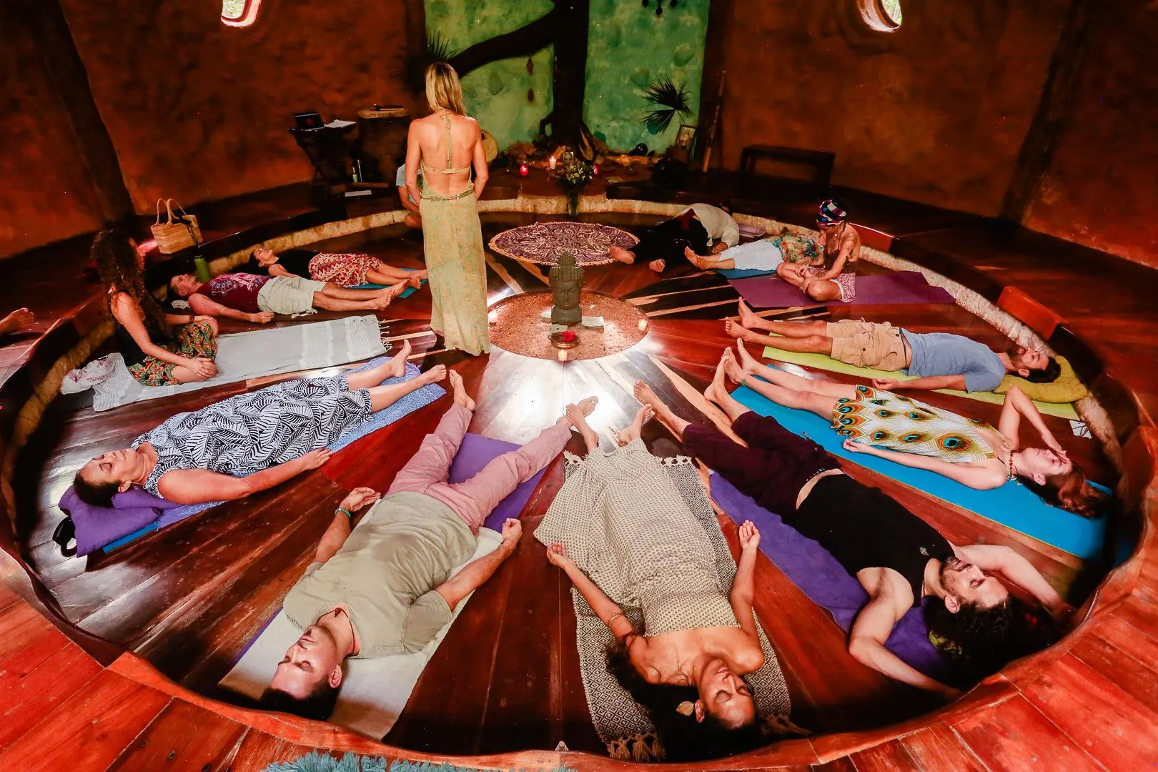 Guests lying in a circle in the temple during a breathwork journey