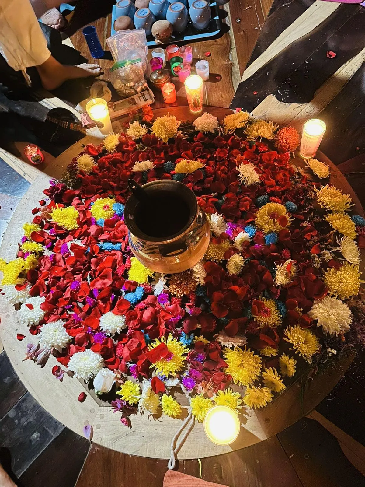 A cacao ceremony altar of flowers and candles
