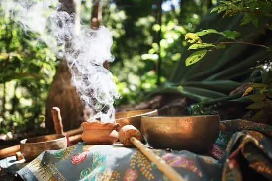 Copal smoke rising from clay bowls in the jungle
