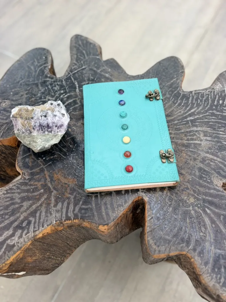 The handmade journal beside an amethyst crystal