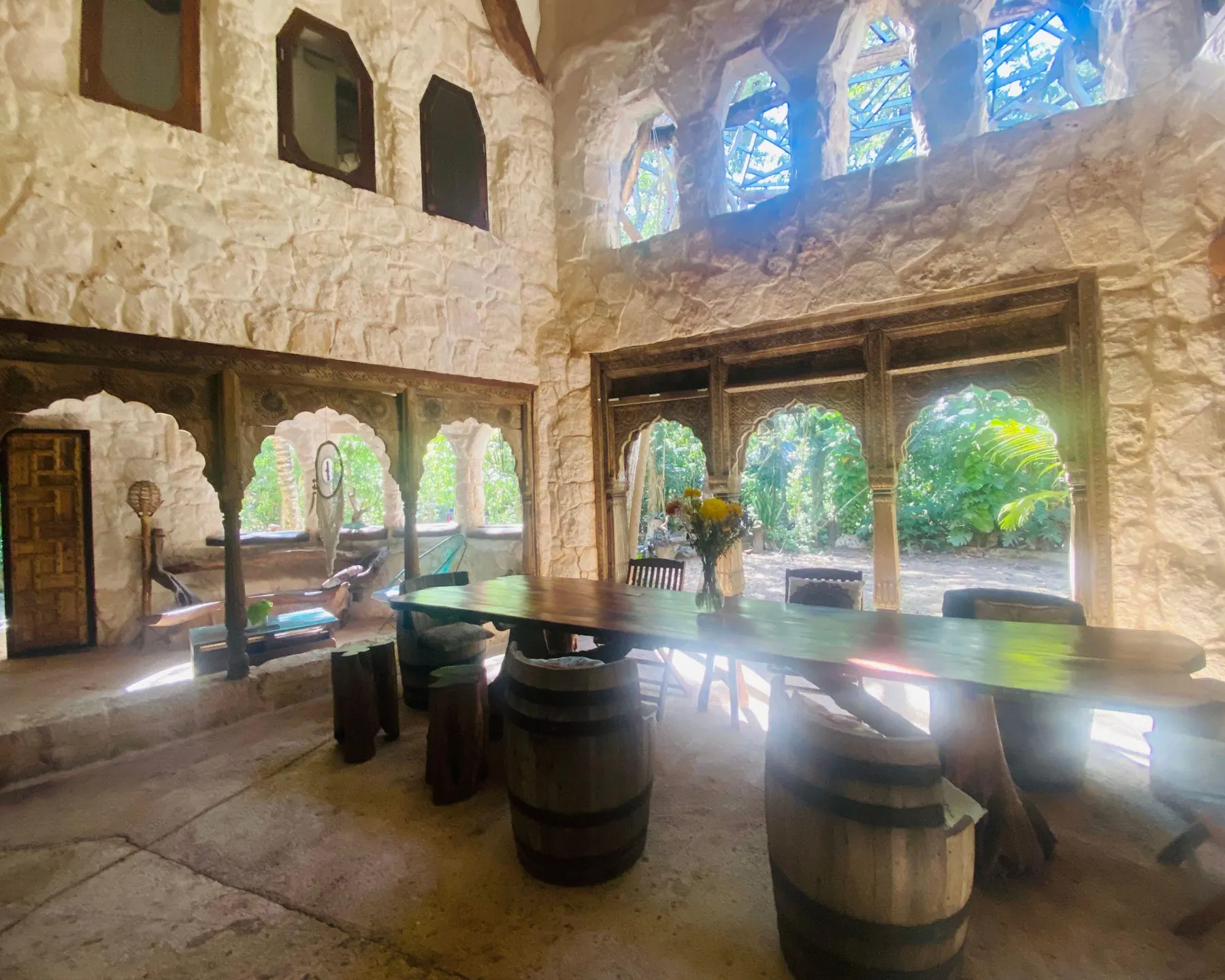 The stone hall of the jungle lodge with arched windows